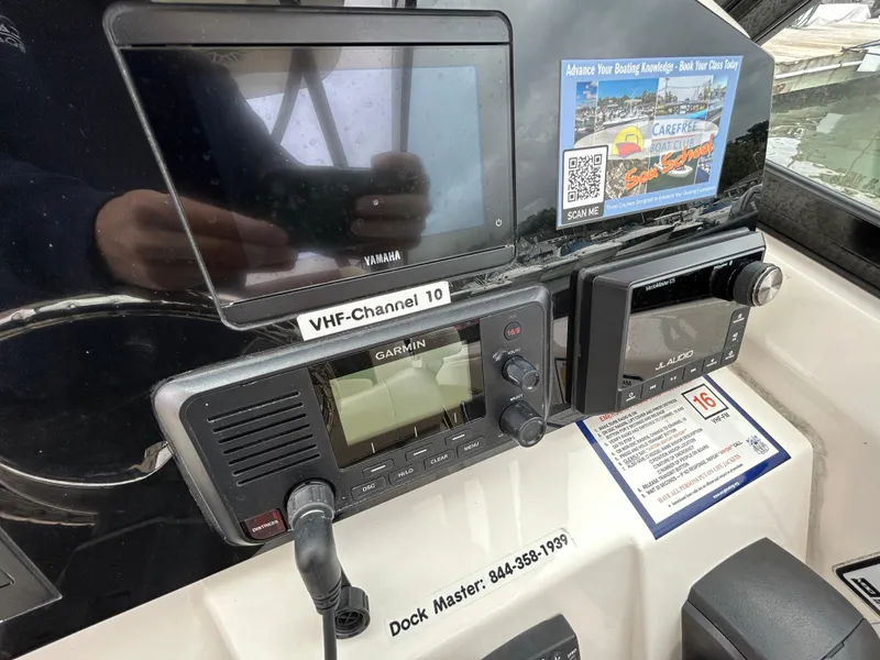 Slide: The Image of 2022 Cobia 240 Dual Console dashboard with Garmin and Yamaha electronics. - 12
