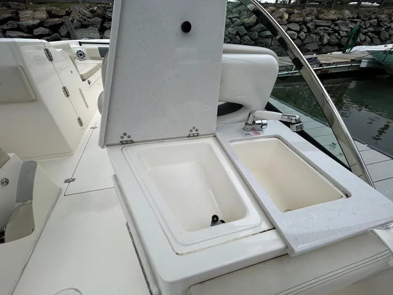 Slide: The Image of 2022 Cobia 240 Dual Console boat with open storage compartments. - 19
