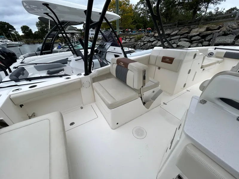 Slide: The Image of 2022 Cobia 240 Dual Console boat interior with seating and storage compartments. - 20