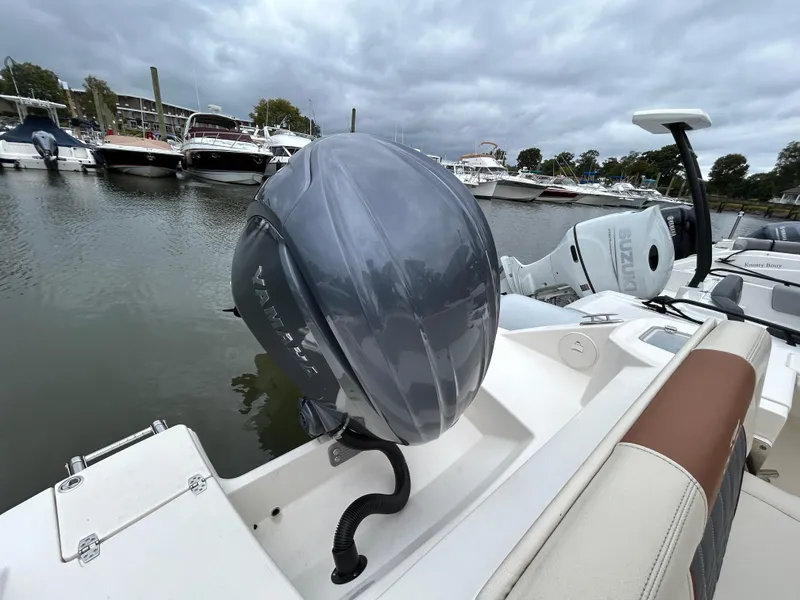 Slide: The Image of 2022 Cobia 240 Dual Console boat with Yamaha outboard motor in marina. - 21