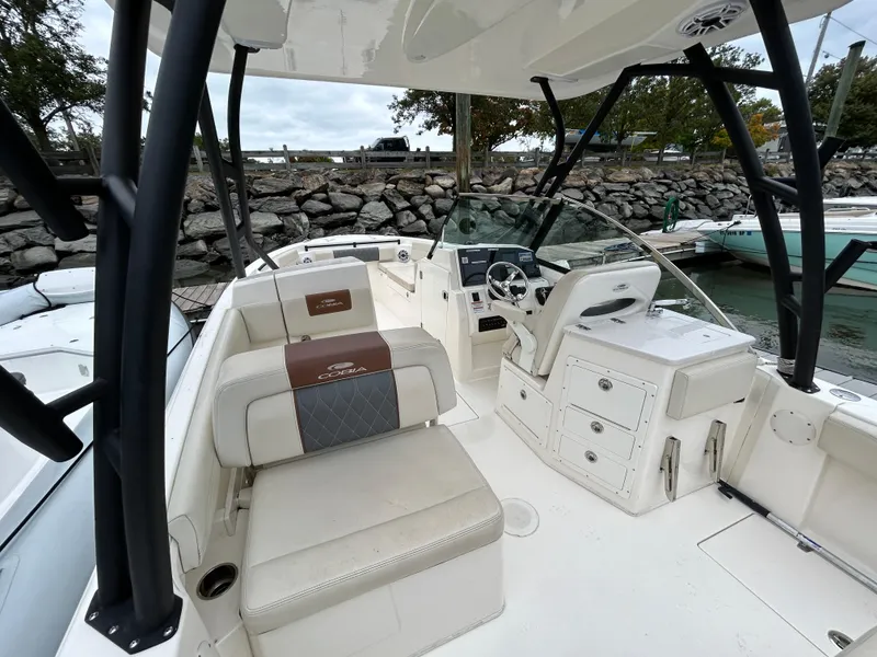 Slide: The Image of 2022 Cobia 240 Dual Console boat interior with seating and steering console. - 23