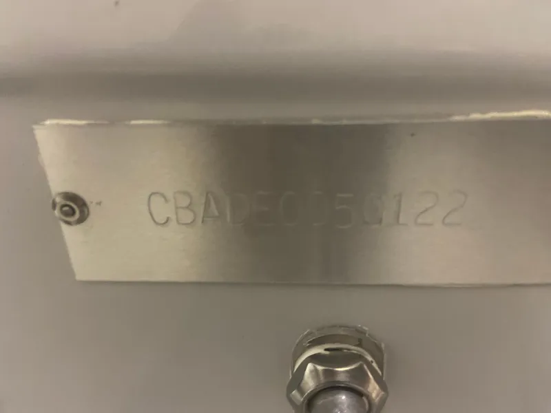 Slide: The Image of Cobia 240 Dual Console 2022, metal plate with serial number CBADE050122. - 32