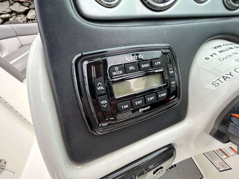 Slide: The Image of Close-up of a 2021 NauticStar 243 DC boat dashboard with audio controls. - 13