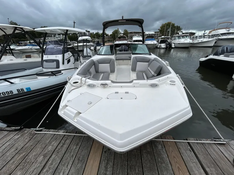 Slide: The Image of 2021 NauticStar 243 DC boat docked at marina under cloudy skies. - 6