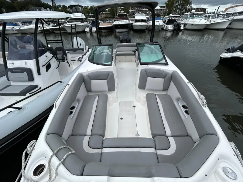 Slide: The Image of 2021 NauticStar 243 DC boat with spacious seating, docked in a marina. - 8