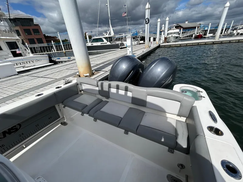 Slide: The Image of 2021 NauticStar 2602 Legacy boat docked with twin engines and spacious seating. - 11