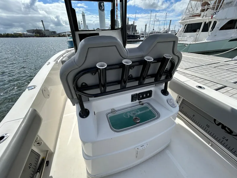 Slide: The Image of 2021 NauticStar 2602 Legacy boat interior with rod holders and seating. - 12
