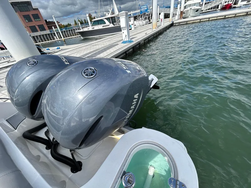 Slide: The Image of NauticStar 2602 Legacy 2021 with twin Yamaha outboard engines at marina dock. - 6