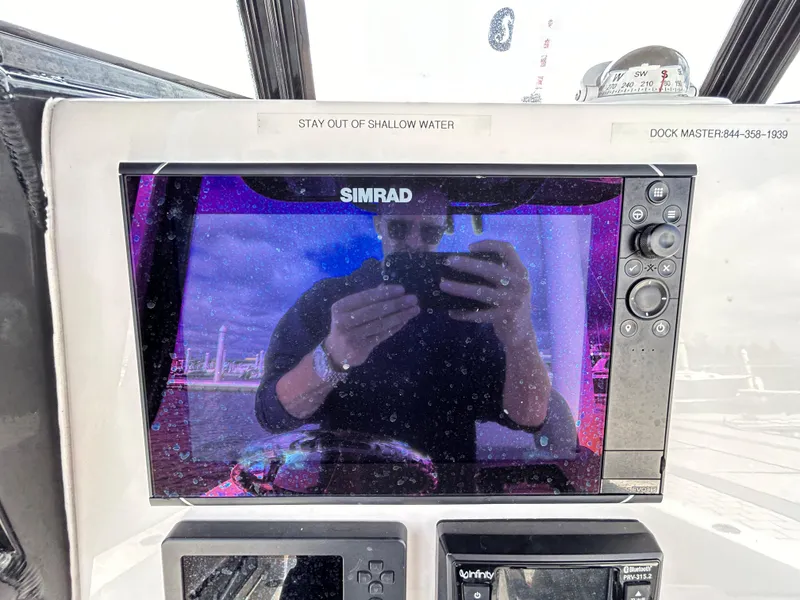 Slide: The Image of Simrad display on 2021 NauticStar 2602 Legacy boat dashboard. - 7
