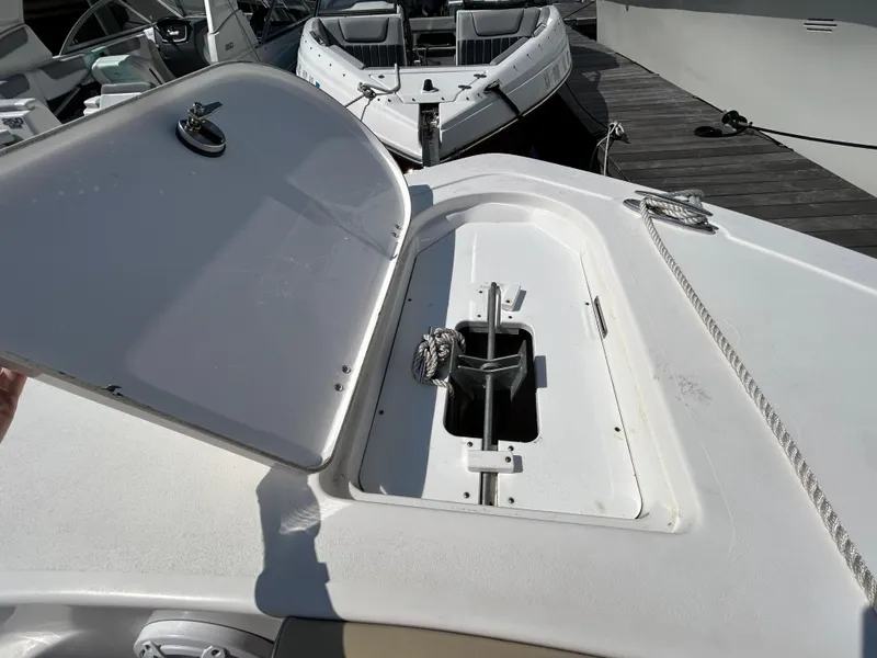 Slide: The Image of 2021 Tidewater 232 LXF boat with open storage compartment on deck. - 10