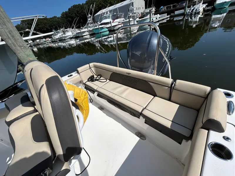 Slide: The Image of 2021 Tidewater 232 LXF boat interior with beige seating at marina. - 13