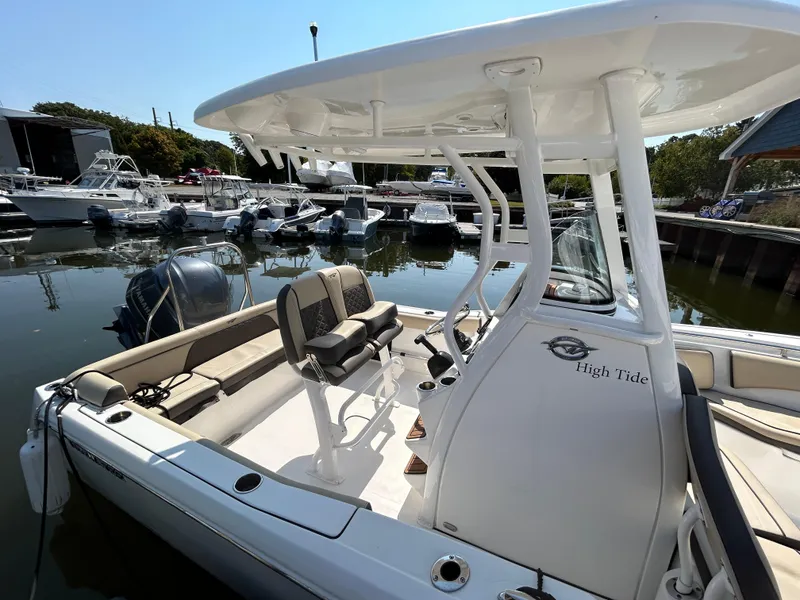 Slide: The Image of 2021 Tidewater 232 LXF boat docked at marina, featuring spacious seating and modern design. - 16