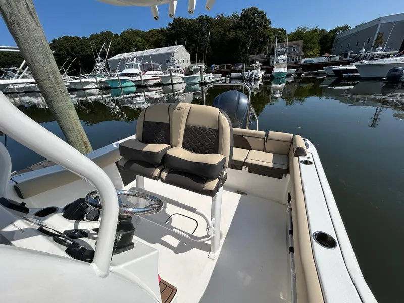 Slide: The Image of 2021 Tidewater 232 LXF boat interior at marina, featuring comfortable seating and modern design. - 3
