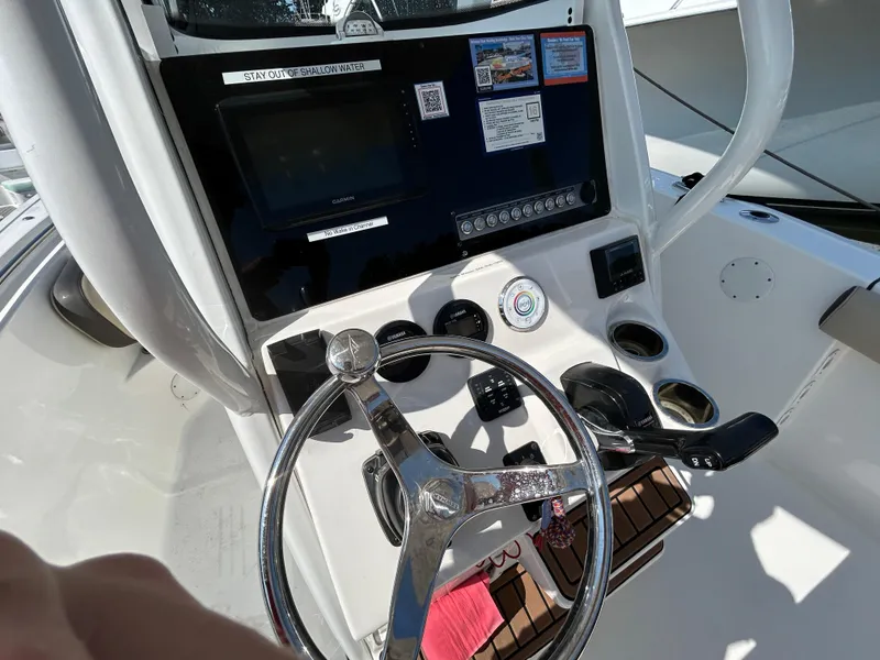 Slide: The Image of 2021 Tidewater 232 LXF boat dashboard with steering wheel and control panel. - 5