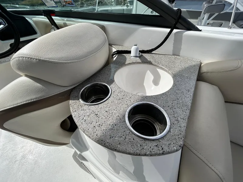 Slide: The Image of 2022 NauticStar 243 DC boat interior with cup holders and sink. - 15