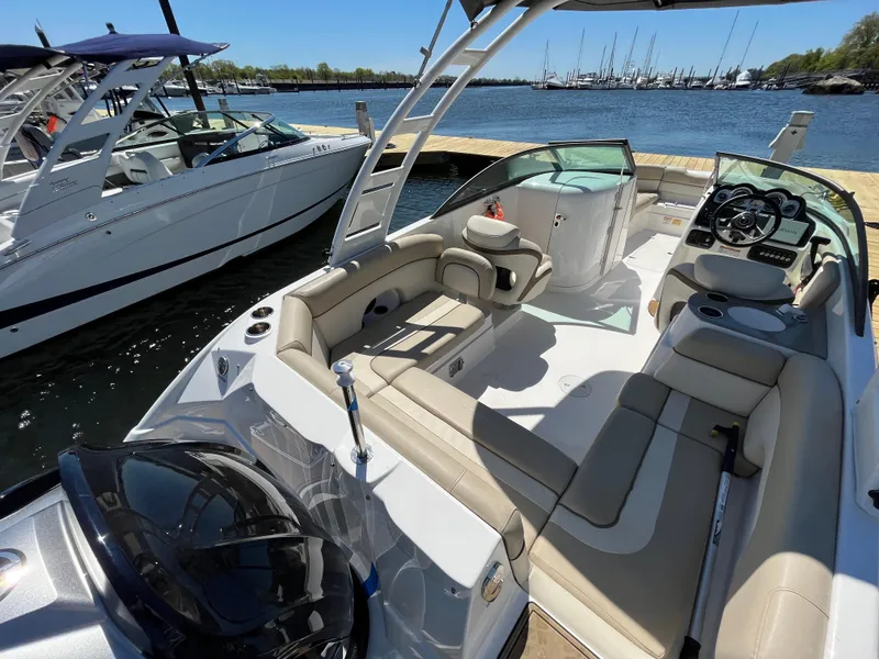 Slide: The Image of 2022 NauticStar 243 DC boat interior at marina, featuring spacious seating and modern design. - 22