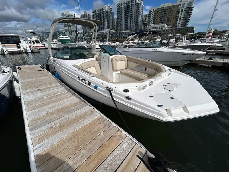 Slide: The Image of 2022 NauticStar 243 DC boat docked at marina with city skyline. - 5