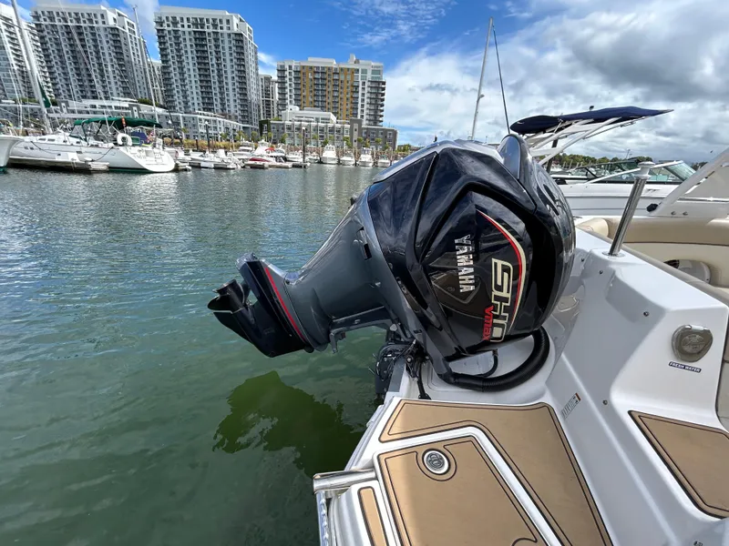 Slide: The Image of NauticStar 243 DC 2022 boat with Yamaha engine docked in marina. - 7