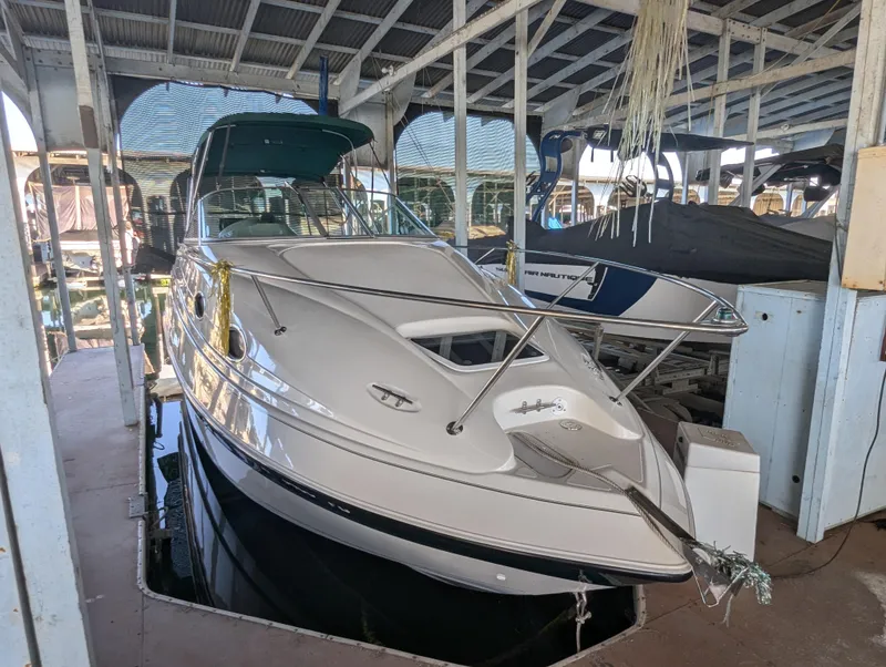 Slide: The Image of 1997 Regal Commodore 242 boat docked in a covered marina. - 1
