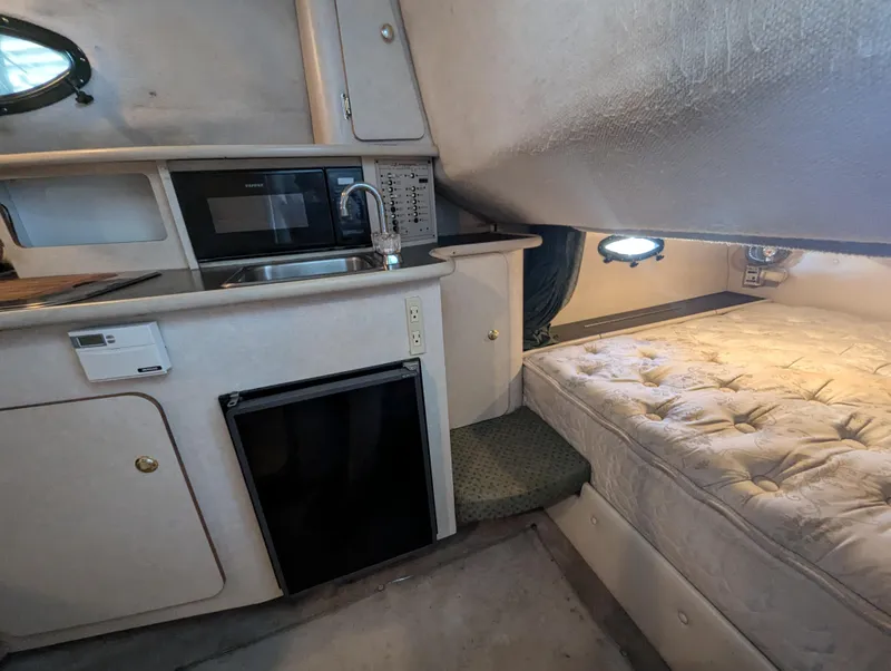 Slide: The Image of Interior of 1997 Regal Commodore 242 boat with kitchenette and sleeping area. - 4