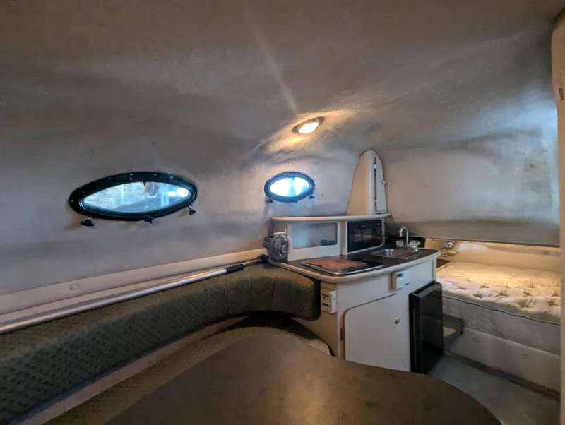 Slide: The Image of Interior of 1997 Regal Commodore 242 boat with kitchenette and seating area. - 5