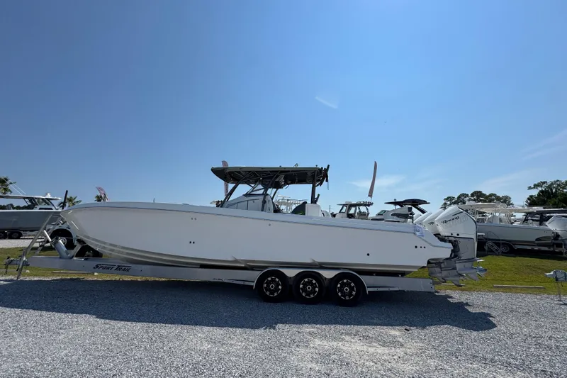 Slide: The Image of 2022 Nor-Tech 392 Super Fish boat on trailer under clear blue sky. - 2