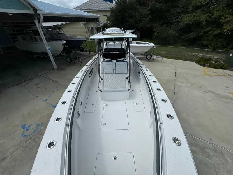 Slide: The Image of 2022 Nor-Tech 392 Super Fish boat, sleek design, spacious deck, parked outdoors. - 21