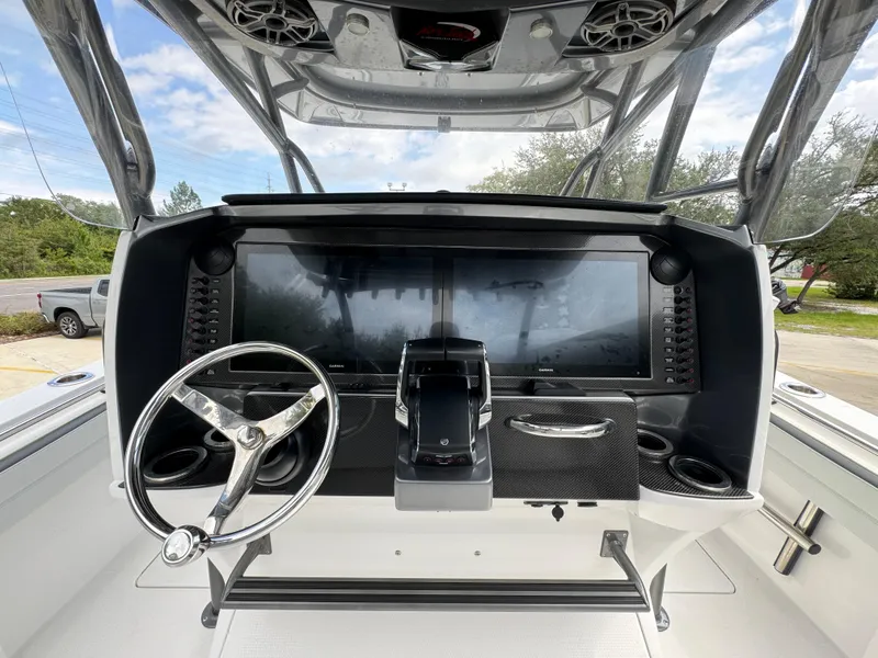 Slide: The Image of 2022 Nor-Tech 392 Super Fish boat dashboard with steering wheel and controls. - 33