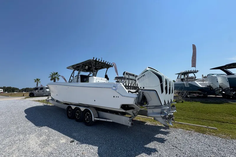 Slide: The Image of 2022 Nor-Tech 392 Super Fish boat with triple outboard engines on a trailer. - 4