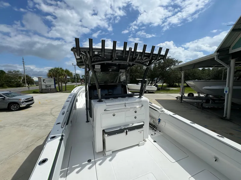 Slide: The Image of 2022 Nor-Tech 392 Super Fish boat with spacious deck and rod holders under a blue sky. - 46