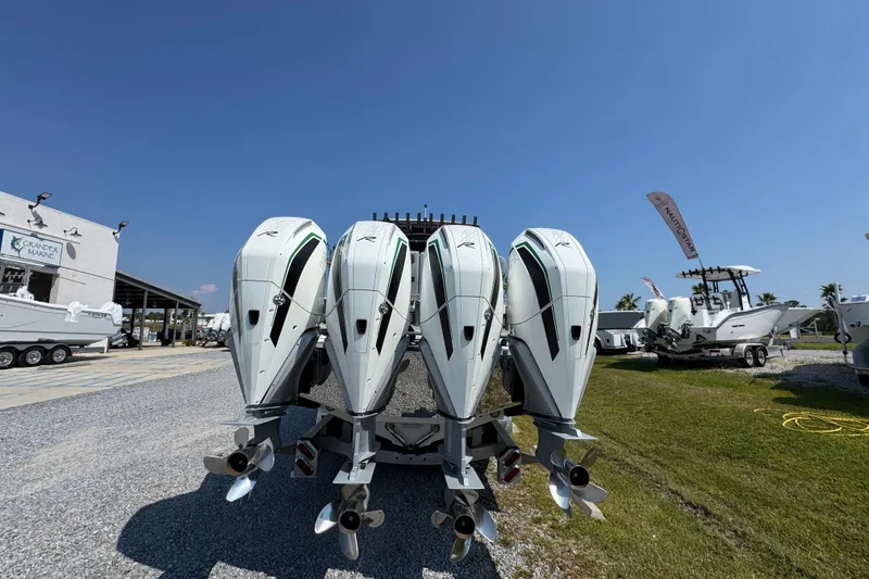 Slide: The Image of 2022 Nor-Tech 392 Super Fish boat with four powerful outboard engines displayed outdoors. - 7