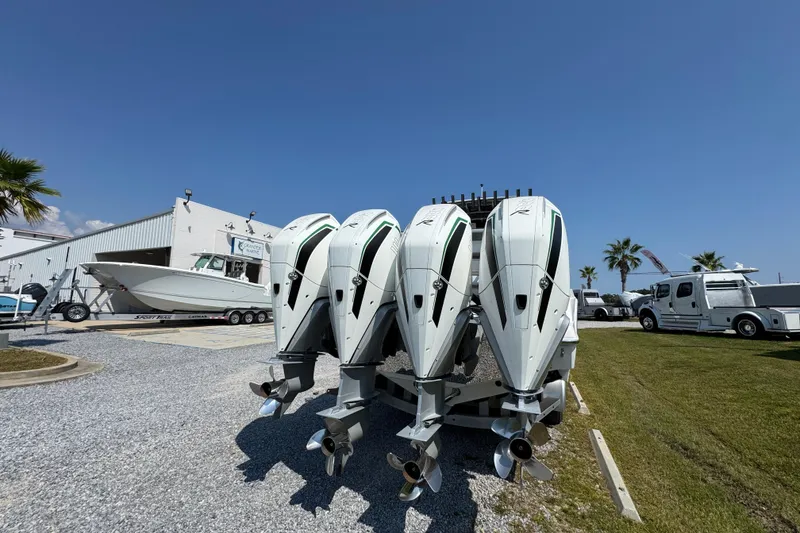 Slide: The Image of 2022 Nor-Tech 392 Super Fish boat with triple outboard engines, parked outdoors. - 8