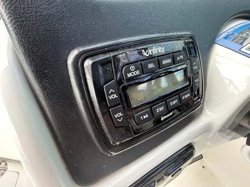 Slide: The Image of Infinity audio system on 2022 NauticStar 243 DC boat dashboard. - 10