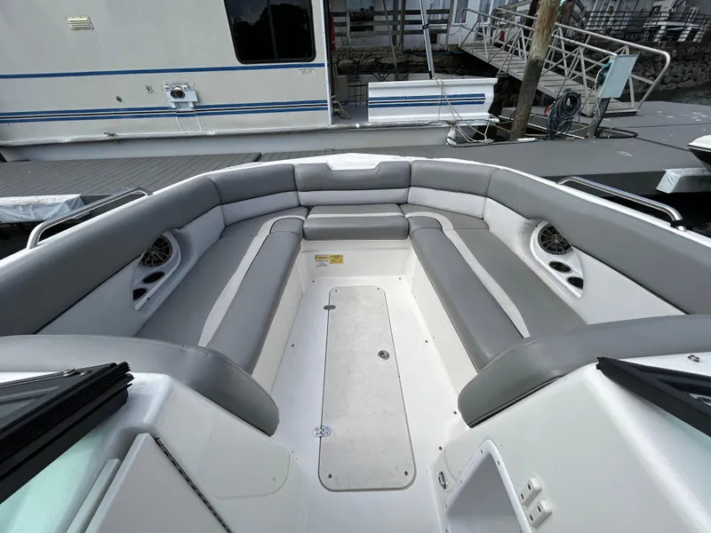 Slide: The Image of 2022 NauticStar 243 DC boat interior with gray seating and spacious layout. - 24