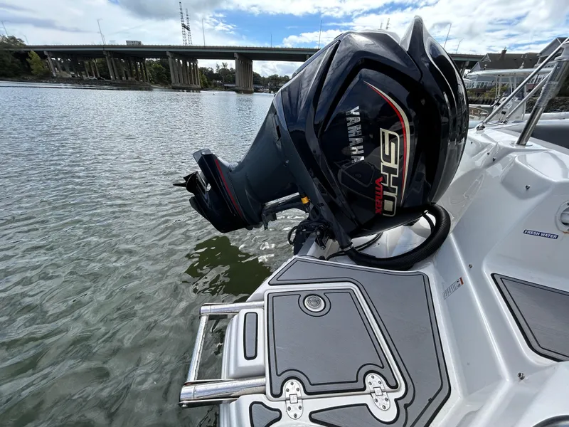 Slide: The Image of NauticStar 243 DC 2022 boat with Yamaha outboard motor on a calm river. - 7