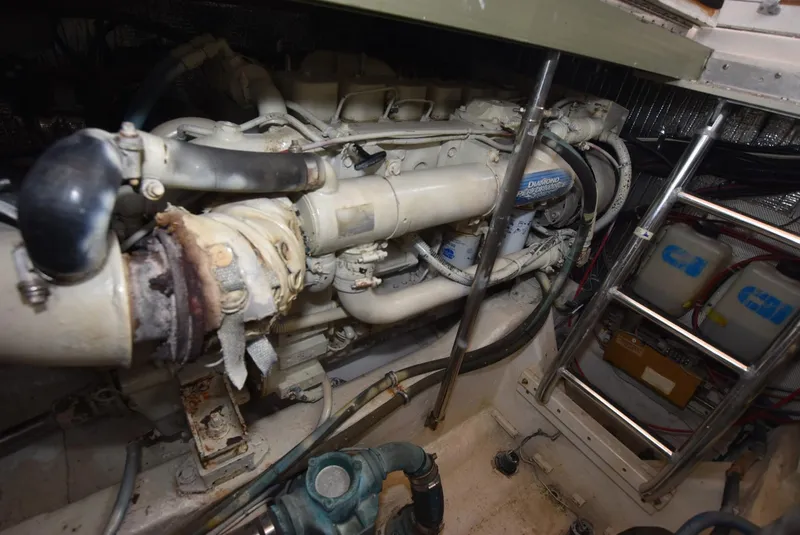 Slide: The Image of Engine room of 1999 Legacy 34 Express boat, showcasing mechanical components and equipment. - 20