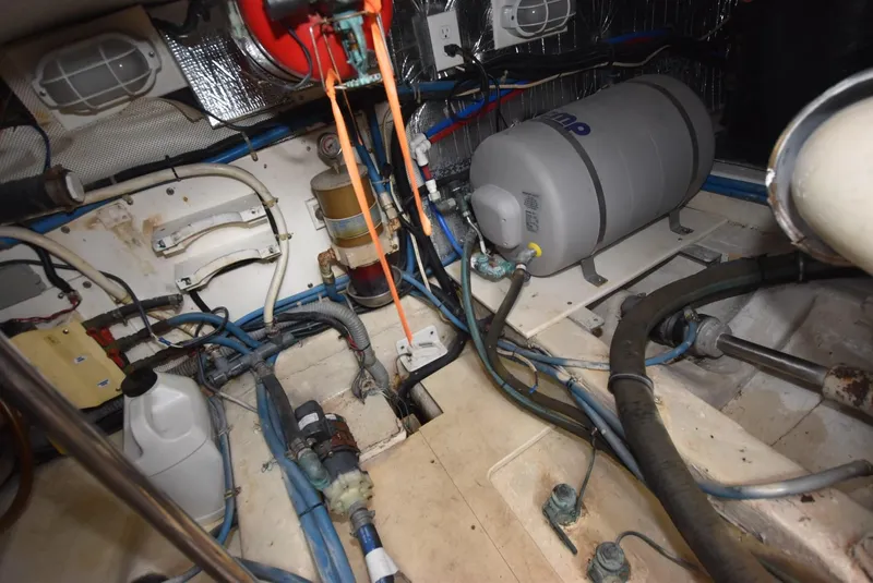 Slide: The Image of Engine room of 1999 Legacy 34 Express boat with various mechanical components. - 21