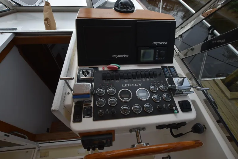 Slide: The Image of 1999 Legacy 34 Express boat dashboard with Raymarine navigation equipment. - 7