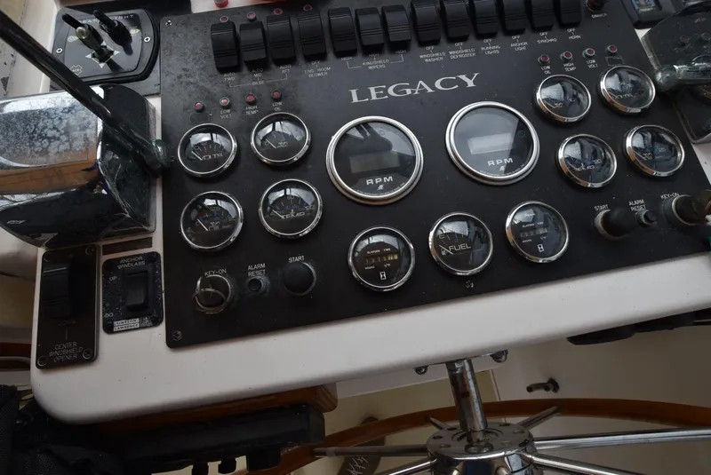 Slide: The Image of Legacy 34 Express 1999 boat dashboard with gauges and controls. - 8