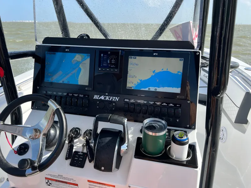 Slide: The Image of 2023 Blackfin 252 CC boat dashboard with navigation screens and controls. - 10