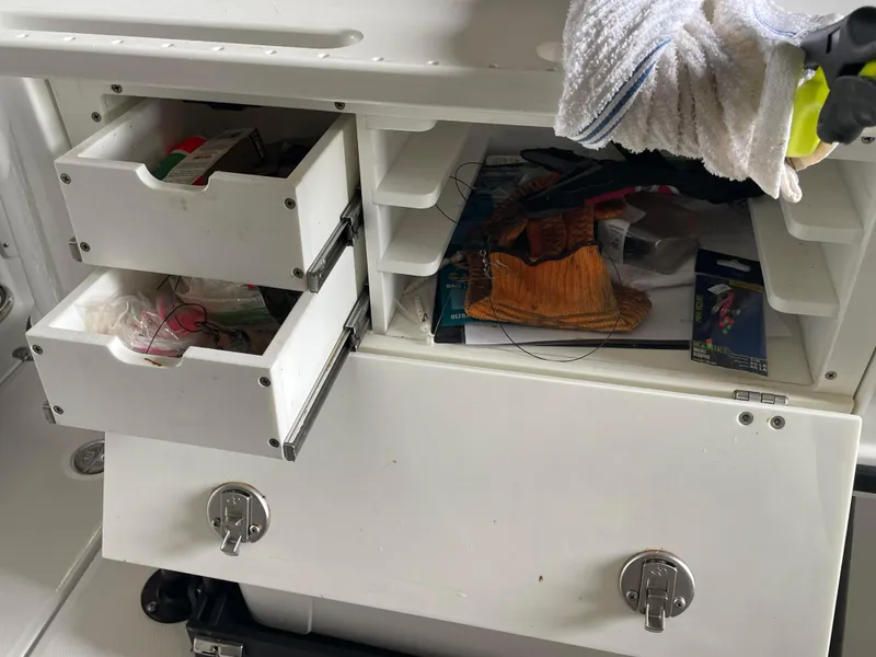 Slide: The Image of Storage drawers on a 2023 Blackfin 252 CC boat, containing fishing gear and accessories. - 25
