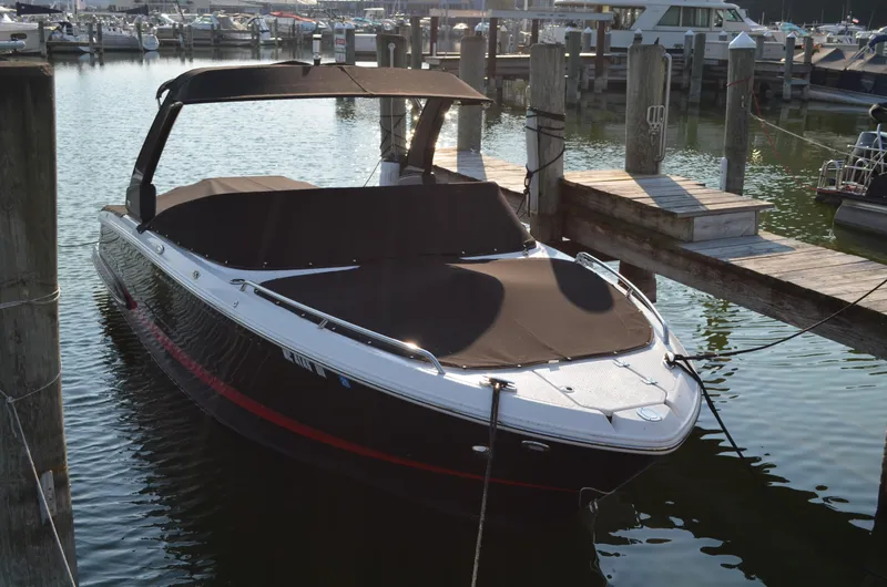 The Image of 2020 Chaparral 257 SSX boat docked in a marina, covered and ready for use. - 0