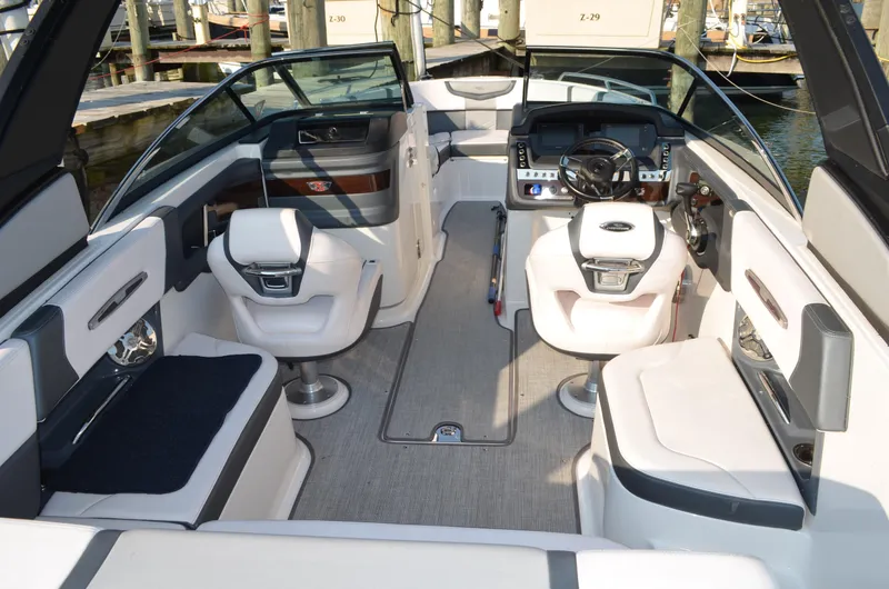 Slide: The Image of 2020 Chaparral 257 SSX boat interior with modern seating and sleek dashboard design. - 11