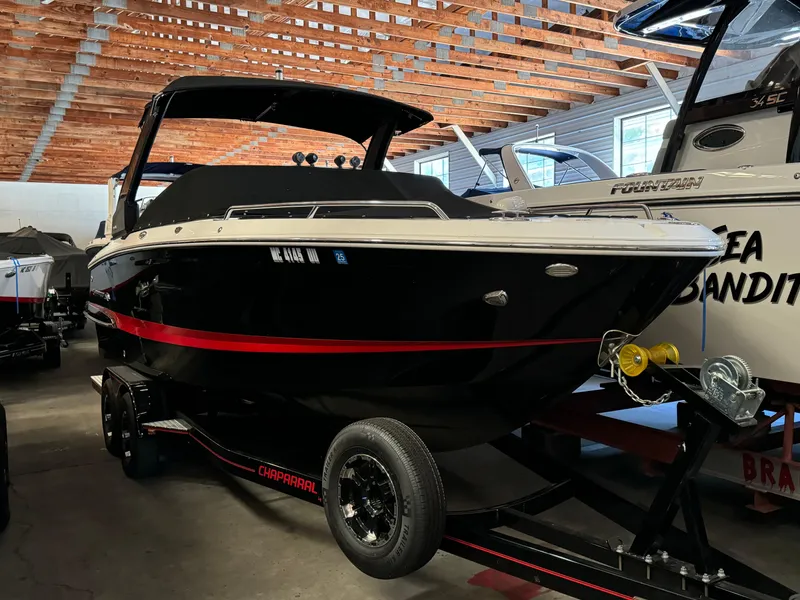 Slide: The Image of 2020 Chaparral 257 SSX boat in storage, black with red stripe, on trailer. - 20