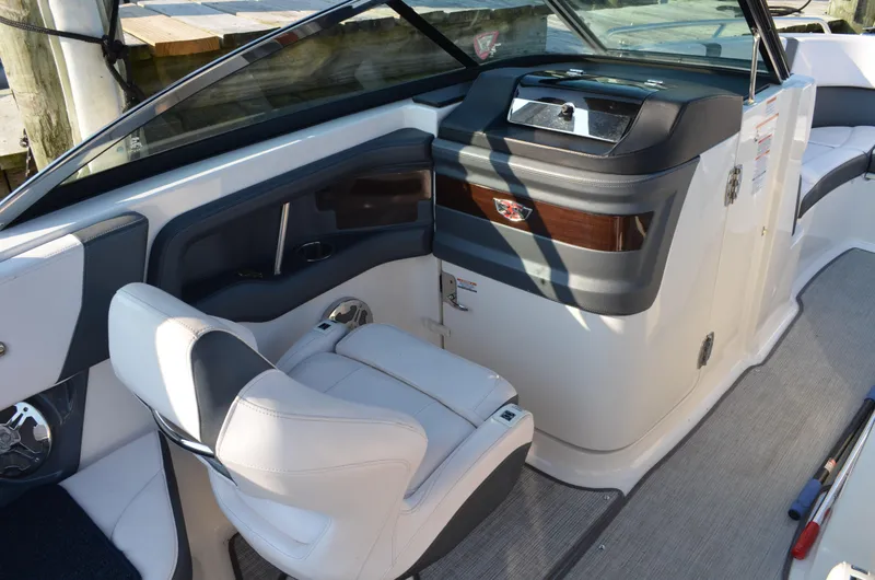 Slide: The Image of 2020 Chaparral 257 SSX boat interior with helm and seating area. - 4