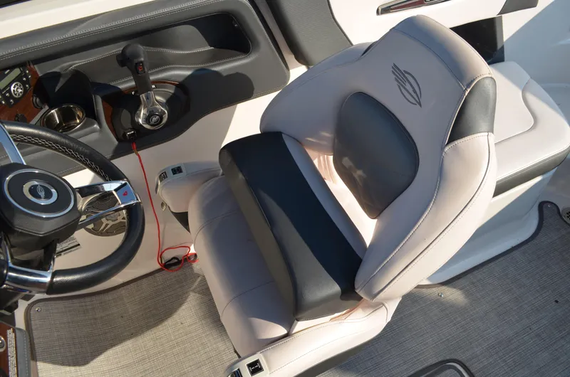 Slide: The Image of 2020 Chaparral 257 SSX boat interior with steering wheel and cushioned seat. - 5