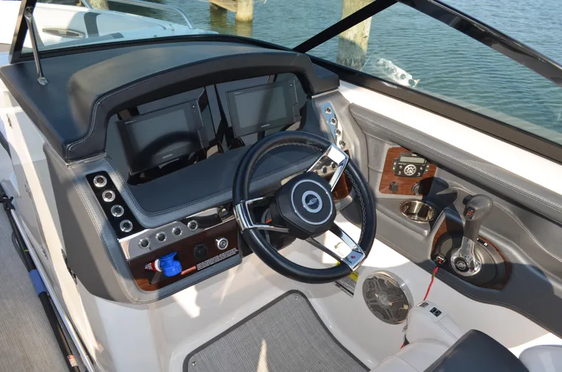 Slide: The Image of 2020 Chaparral 257 SSX boat dashboard with steering wheel and control panel. - 7