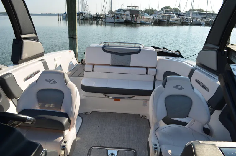 Slide: The Image of 2020 Chaparral 257 SSX boat interior with seating, docked at marina. - 9