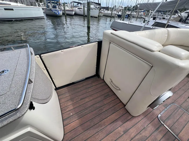 Slide: The Image of 2015 Harris FloteBote Grand Mariner SL 250 interior with beige seating and wooden deck. - 18
