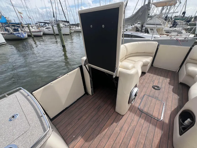 Slide: The Image of 2015 Harris FloteBote Grand Mariner SL 250 interior with seating and wood flooring at marina. - 20